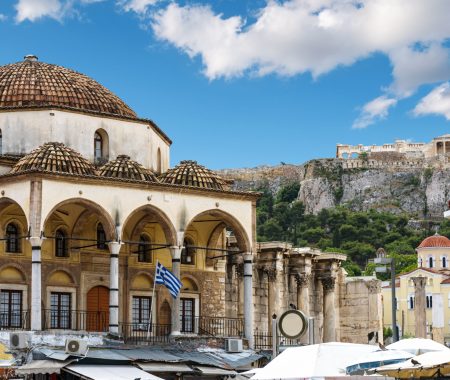 Monastiraki square with old mosque and view of Acropolis, Athens, Greece. Monastiraki is one of main tourist attractions in Athens. Historical architecture and market in Athens city center in summer.